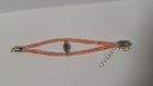 Bracelet en résille tubulaire blanche, strass couleur ambre, connecteur fleur