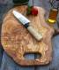A cutting board with hand made with olive wood