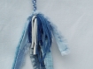 Porte-clef ou bijou de sac en rubans bleus avec une plume en jean et un pompon bleu et blanc