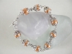 Bracelet perles de verre nacrées oranges et coupelles argentées .