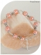 Bracelet perles de verre nacrées saumon . fermoir mousqueton .