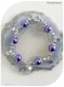 Bracelet perles nacrées violettes et breloques étoiles.