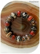 Bracelet élastique perles de verre rouges, marron, rousses .