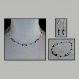 Ensemble collier, bracelet et boucles d'oreilles en chaine cobra argentée garnie de facettes bleu-pâle et de perles noires