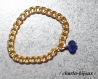 Bague chaîne dorée et perle bleue saphir
