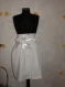 Ladies white skirt with set and non-standard fastening, lining and belt with satin ribbon