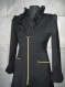 Ladies black mantle with gold zippers, made of black elastic fabric, plastic gold zips, model is size -