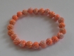Bracelet élastique en perles oranges motif spiral argent