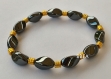 Bracelet bien-être en hématite perles torsadées et perles tonneau dorées argent du tibet 