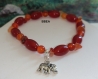 Bracelet cornaline,pierre des blocages sexuels, perles olives,6mm et chips, breloque éléphant argent du tibet. 