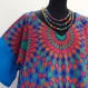 Tunique poncho en laine tissée bleue et brodée de dessins rosaces multicolores , col rond ,manches courtes 