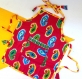 Tablier de cuisine enfant rose fuchsia et jaune en coton motifs paisley 