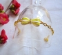 Bracelet métal doré et noeud jaune et blanc 