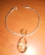 Joli ras de cou en fil alu doré strié 2 mm torsadé à la main avec un pendentif cristal. 
