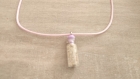Collier fiole remplie de sable normand en fimo et verre sur cordon coton rose 