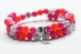 Bracelet d'allaitement sur fil à mémoire de forme de 55mm avec perles en acrylique de couleur rose et orange flashy 