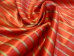 Coupon de tissu carnaval en polyester rayé or et rouge 