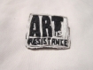 Broche brodée de perles et de fil "art is resistance", noir et blanche. 