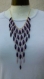 Collier plastron mauve et violet en perles synthétiques 