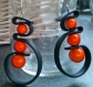 Boucles d'oreille pendantes pvc noir et perles magiques orange 