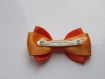 Barrette plastique 4 cm avec noeud papillon en tissu orange et abricot 
