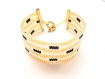 Très joli bracelet noir, blanc et doré tissé en perles miyuki 