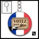 Porte clés couleur argentée cabochon 25 mm en résine motif votez pour moi ( 1979 ) - election, président 