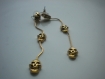 Boucles d'oreilles trio de têtes de mort en métal doré