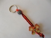 Porte clefs cordon orange fluo tressé, bouton forme nœud et perle 